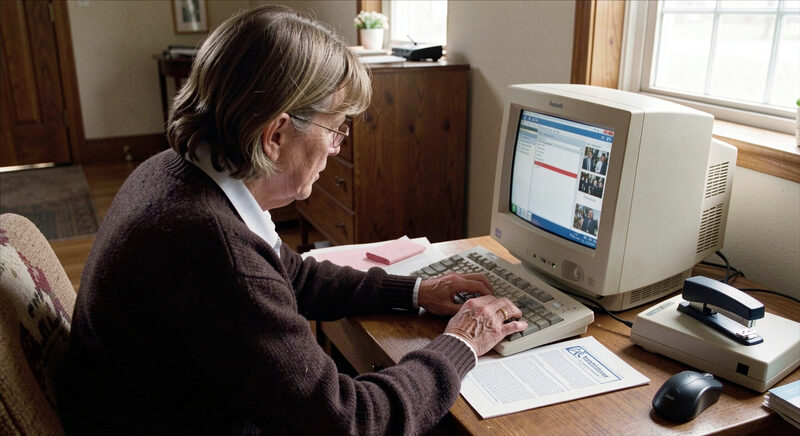 A church volunteer typing on a home computer beside a printed newsletter and a stapler, late 1990s.